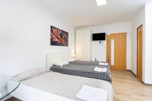 a bedroom with two beds and a glass table at Maoli A Central Studio Icod de los Vinos in Icod de los Vinos +15 photos