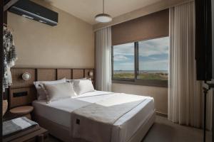 a bedroom with a large bed and a window at Pournari Center Toroni in Toroni