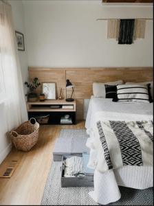 a bedroom with a bed and a table in it at 4cs apartment in Bayanan