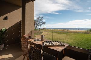 a table on a balcony with a view of the ocean at Pournari Center Toroni in Toroni