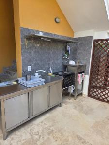 a kitchen with a sink and a stove at Hotel ADMIRAL POTOS THASSOS in Potos +68 photos