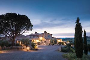 an estate in the hills at dusk at Dimora Santa Margherita - Boutique Hotel in Cinigiano