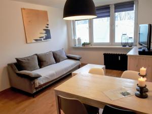 a living room with a couch and a table at Studio park Katowice/Chorzów in Chorzów