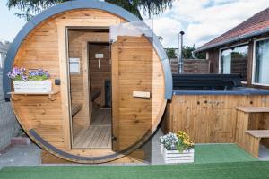 a circular wooden building with a circular door at Agroturystyka Przy Wodospadzie in Lubrza