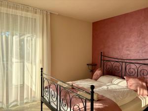 a bedroom with a bed and a window at Gruber Apartman in Siófok