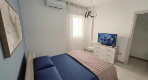 a bedroom with a bed and a tv on a dresser at Viben House in Gallipoli