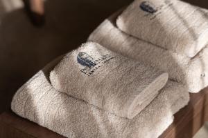 a pile of towels sitting on top of a table at Pournari Center Toroni in Toroni +99 photos