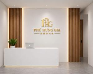a reception desk with a laptop on top of it at Phú Hưng Gia Motel in Ðức Hòa