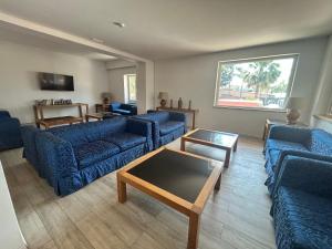 a living room with blue couches and a table at Hotel Giardino d'Europa in Rome