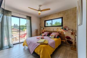 a bedroom with a bed with a yellow blanket at Tomland in Parentis-en-Born +36 photos