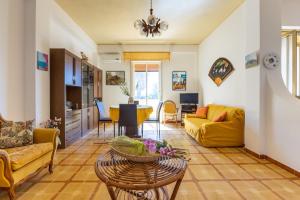 a living room with a couch and a table at Villa Preside in Noto Marina