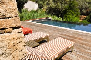 two lounge chairs and a swimming pool in a yard at L'Orangeraie d'Afa in Afa