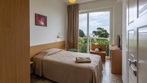 a hotel room with a bed and a balcony at Baby Gigli in Numana +87 photos