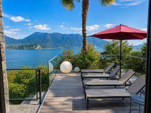 a deck with chairs and a view of the water at Villa Spa Chiara Luna by Lago Reisen in Oggebio