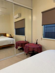 a bedroom with a large mirror and a bed at Lake Macquarie holidays in Marks Point