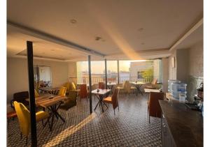 a restaurant with tables and chairs and a large window at Hotel Tulip House in Istanbul