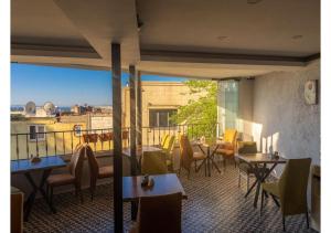 a restaurant with tables and chairs and a balcony at Hotel Tulip House in Istanbul
