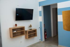 a living room with a television on a wall at Bilo 66 in Palmi