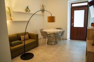 a living room with a couch and a table at Bilo 66 in Palmi +17 photos