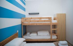 a bunk bed room with two bunk beds in it at Bilo 66 in Palmi
