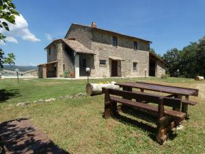 a picnic bench in front of a stone building at SCAPPO IN UMBRIA, casale al lago in Corbara +43 photos