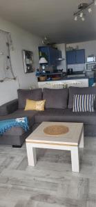 a living room with a couch and a coffee table at SUPERBE VUE sur la MER in Le Grau-dʼAgde +2 photos