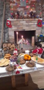 a table with food on it in front of a fireplace at Alpine Lodge Bakhmaro in Chʼkhakoura +54 photos