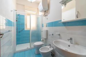a bathroom with a sink and a toilet and a shower at Villa Preside in Noto Marina +45 photos