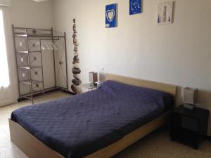 a bedroom with a bed with a blue comforter at SUPERBE VUE sur la MER in Le Grau-dʼAgde