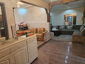 a living room with a couch and a large mirror at La Casa de Larache in Larache