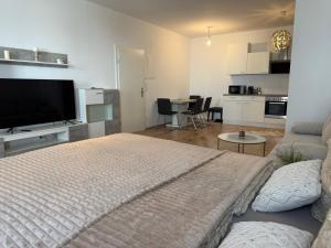 a bedroom with a bed and a living room at Excelsior in Graz