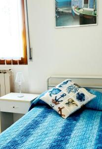 a bedroom with a bed with a pillow on it at Luna e Sentidu in Villaputzu