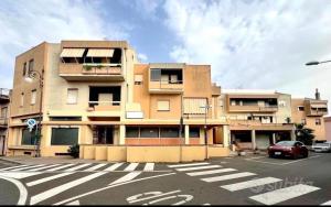 a building with a car parked in a parking lot at Luna e Sentidu in Villaputzu