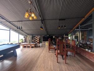 a room with a ping pong table and chairs at Moonlight Chillers By LexStays in Yedapalli