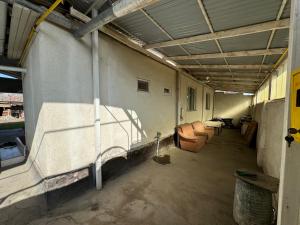 a room with a couch and chairs in a building at Дом in Bishkek