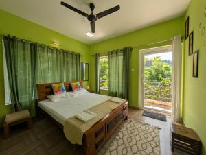a green bedroom with a bed and a window at Moonlight Chillers By LexStays in Yedapalli +70 photos