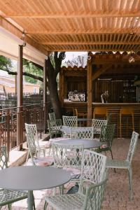 a patio with tables and chairs under a wooden ceiling at L'Orangeraie d'Afa in Afa