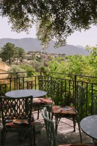 a table and chairs sitting on a patio with a view at L'Orangeraie d'Afa in Afa