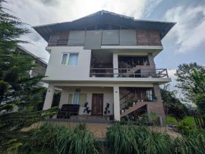 a large white house with a balcony at Moonlight Chillers By LexStays in Yedapalli