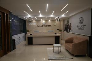 a lobby with a waiting room with a desk and a chair at Galaxy Air Suites in Bangalore
