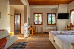 a bedroom with a bed and a desk in a room at KissosInn in Kissos