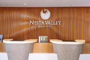 a lobby of a restaurant with a sign on a wall at Nesta Valley Dalat Hotel - Formerly Golf Valley Hotel in Da Lat