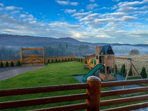 a playground with a slide at Cabana Bocus in Păltinoasa