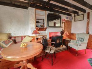 a living room with a table and a stove at 4 Whiterow in Appin