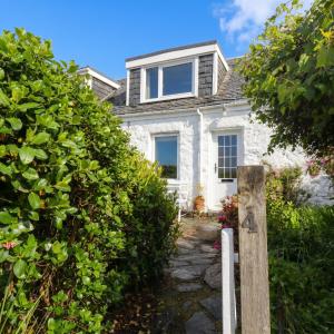 a white stone house with a pathway leading to it at 4 Whiterow in Appin +6 photos