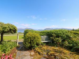 a bench sitting in a garden with a view at 4 Whiterow in Appin