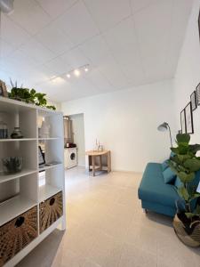 a living room with a blue couch and a table at Ottanio 2 Lake Apartments in Pisogne