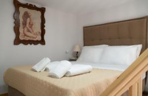 a bedroom with a bed with towels on it at Christie's Home Meteora in Kalabaka