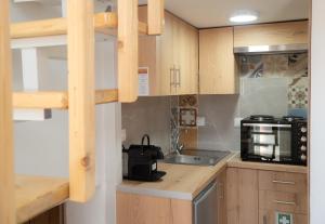 a small kitchen with a sink and a microwave at Christie's Home Meteora in Kalabaka