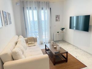 a living room with a white couch and a coffee table at Breeze La Marsa in Tunis